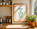 Framed print with 'Snug as a bug in a rug' text in a kitchen setting.