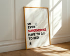 Framed poster with humorous superhero quote on a wall.