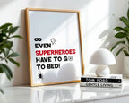 Framed poster with superhero quote on a shelf with decor items