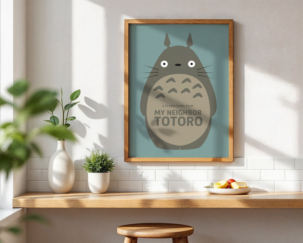 Framed 'My Neighbor Totoro' artwork on a wall with a wooden shelf below.