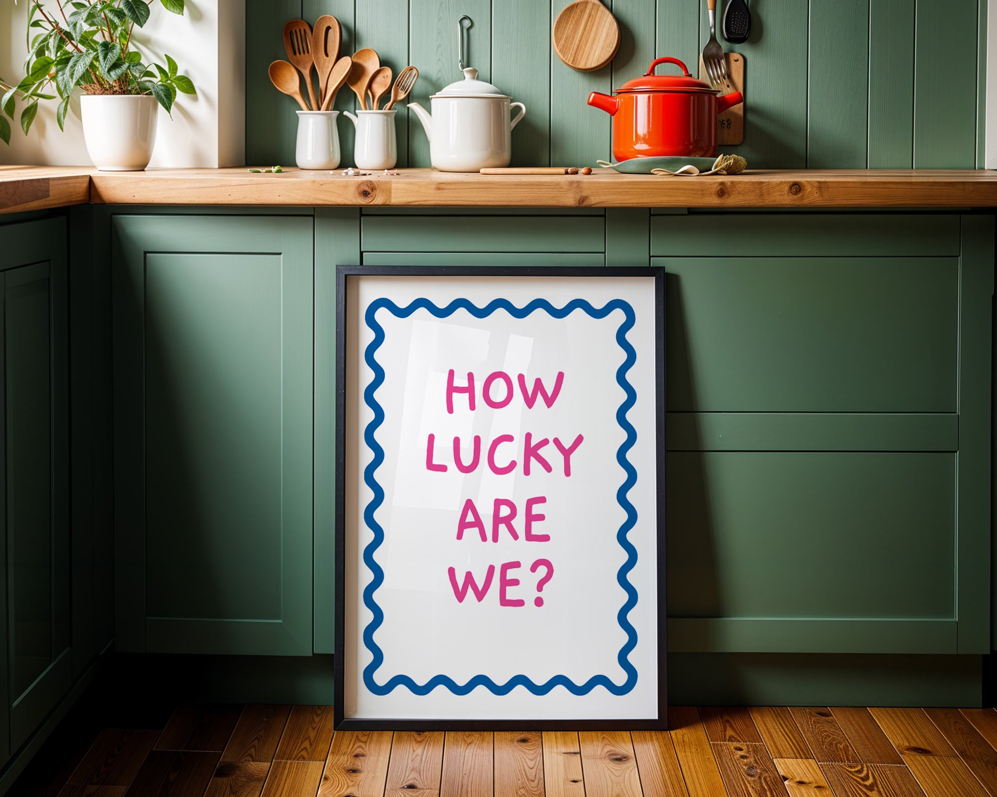 Framed picture with 'How lucky are we?' text in a kitchen setting