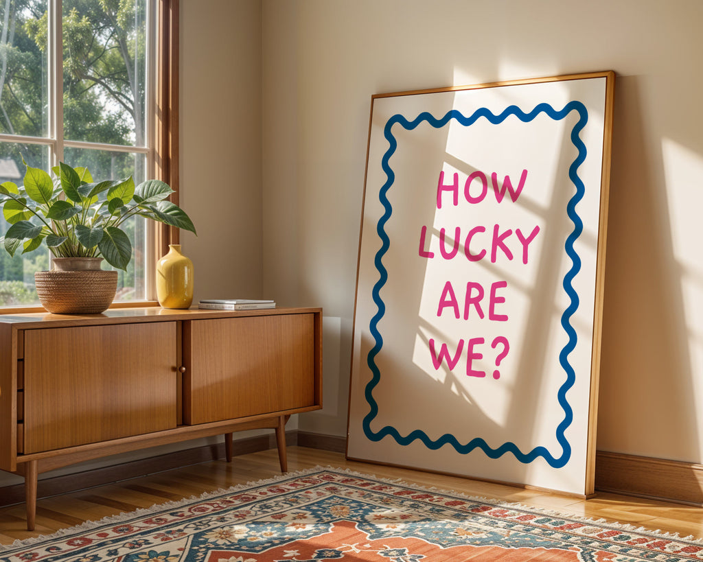 Room interior with a wooden sideboard, plant, and large framed poster with text.